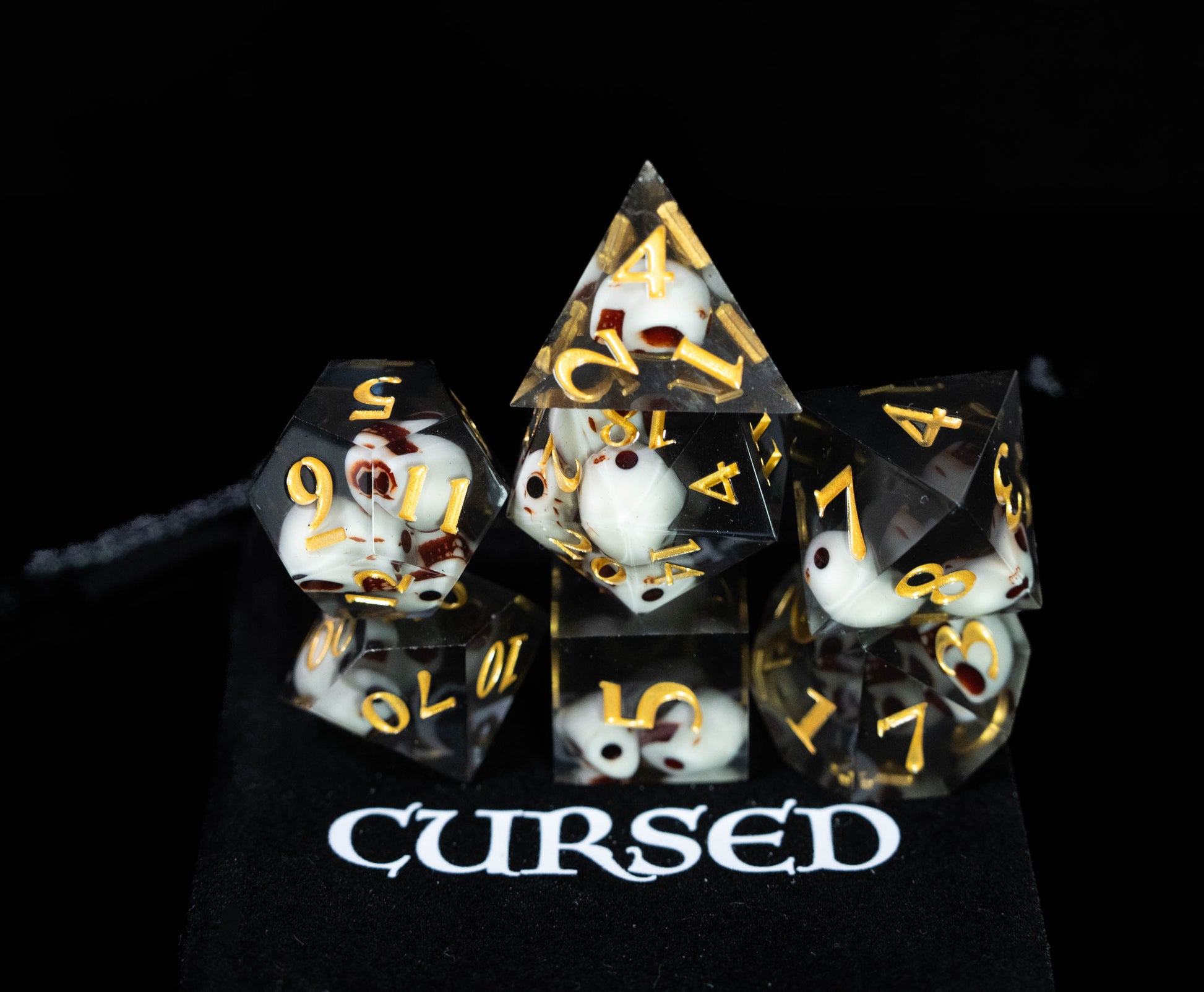 cursed black sharp edge resin skull design dungeons and dragons (aka dnd or d&d) game dice set, including a d20, d12, d10, d8, d6, and d4