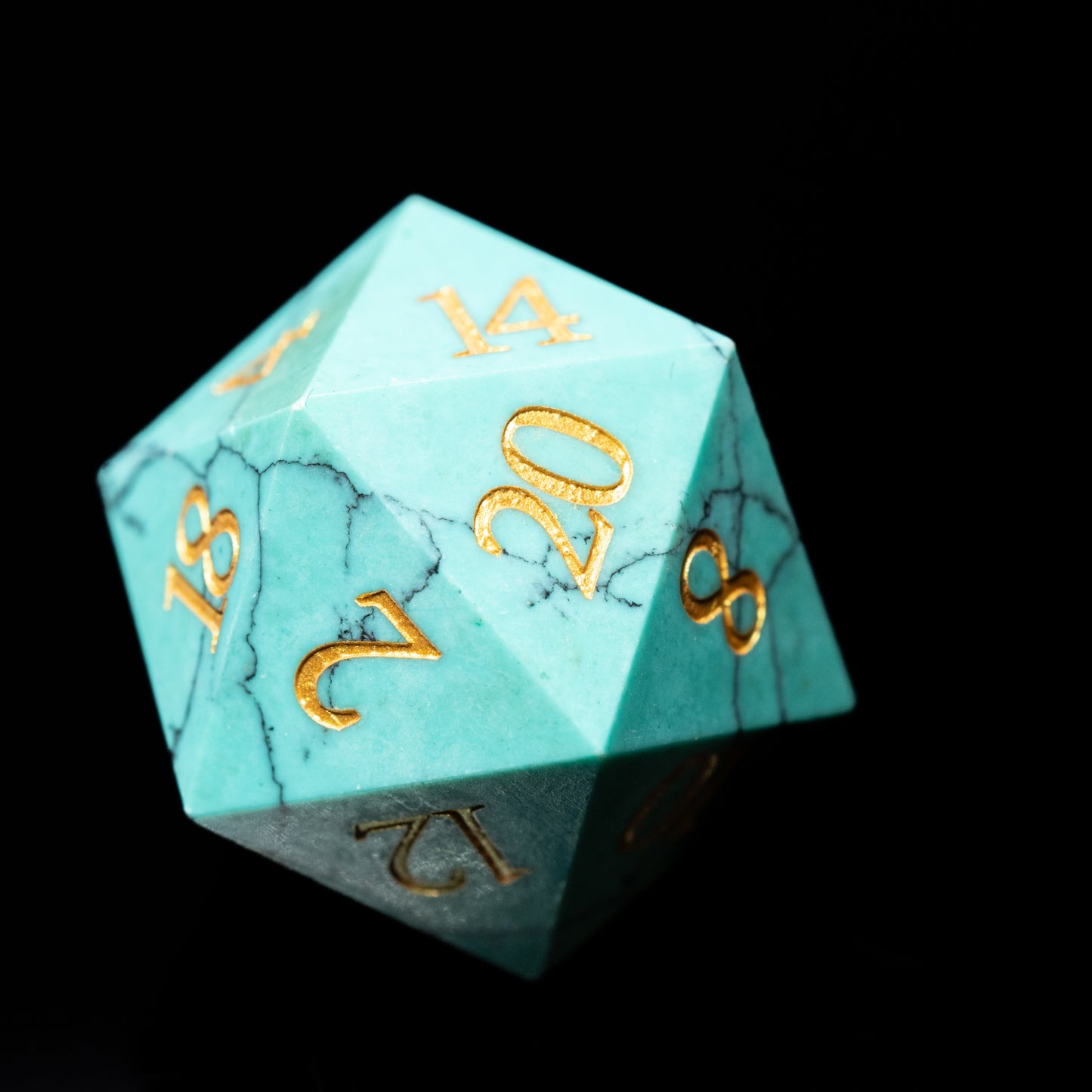 turquoise glass gemstone dungeons and dragons (aka dnd or d&d) d20 game die or dice with gold numbers on a black background