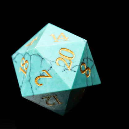 turquoise glass gemstone dungeons and dragons (aka dnd or d&d) d20 game die or dice with gold numbers on a black background