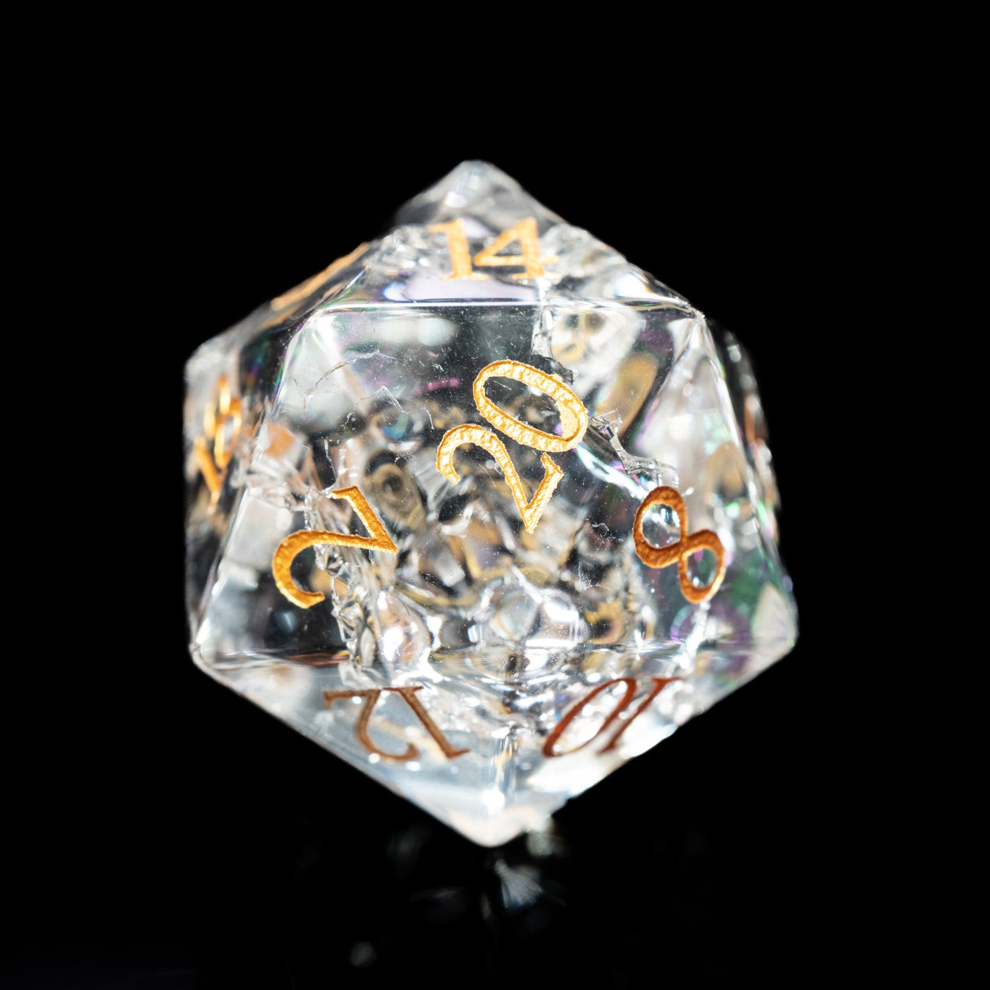 Clear crystal glass gemstone dungeons and dragons (aka dnd or d&d) d20 game die or  dice with gold numbers on a black background