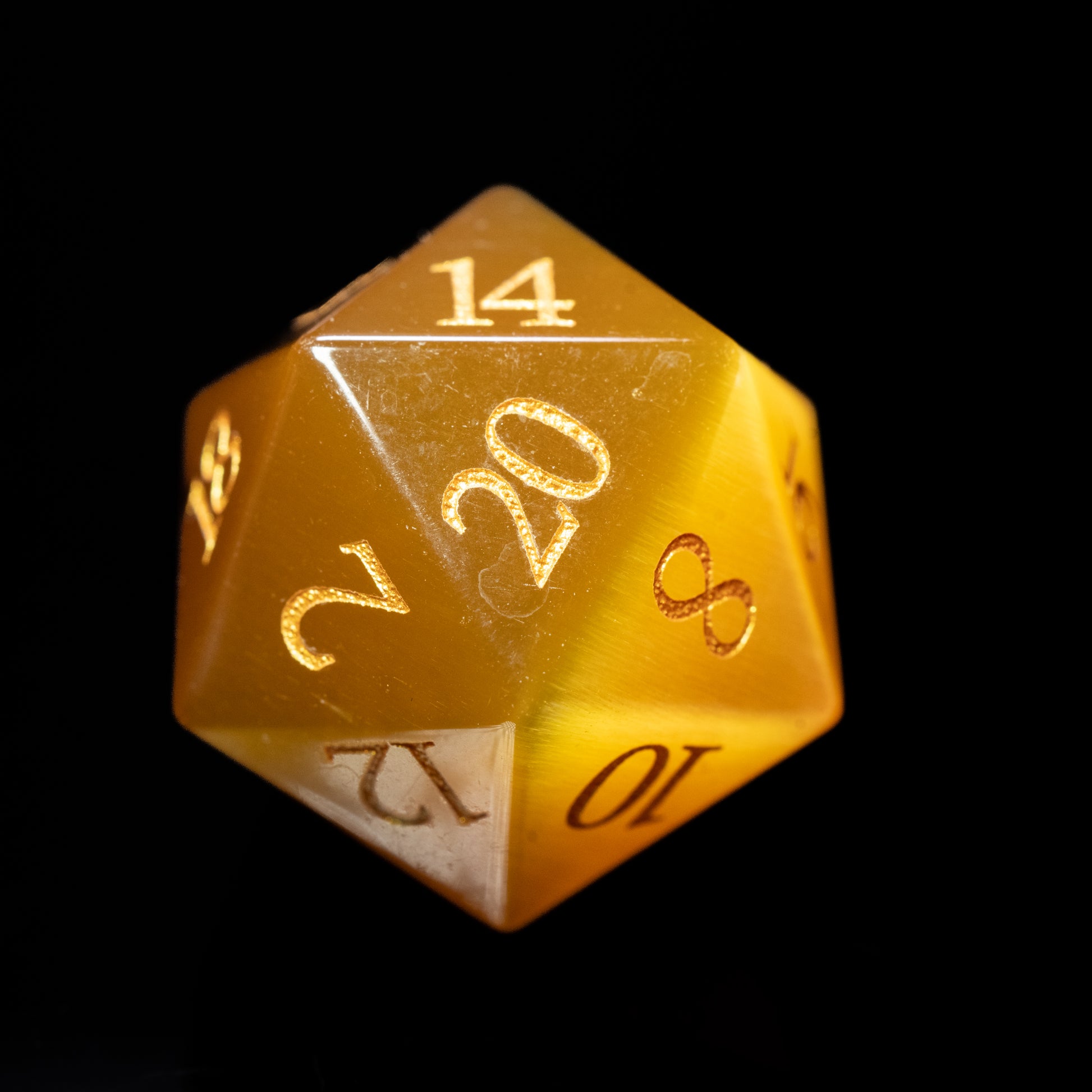orange act's eye glass gemstone dungeons and dragons (aka dnd or d&d) d20 game dice or die with numbers on a black background