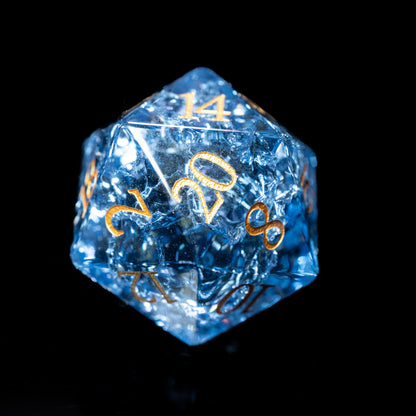 blue glass gemstone dungeons and dragons (aka dnd or d&d) d20 game die or dice with gold numbers on a black background