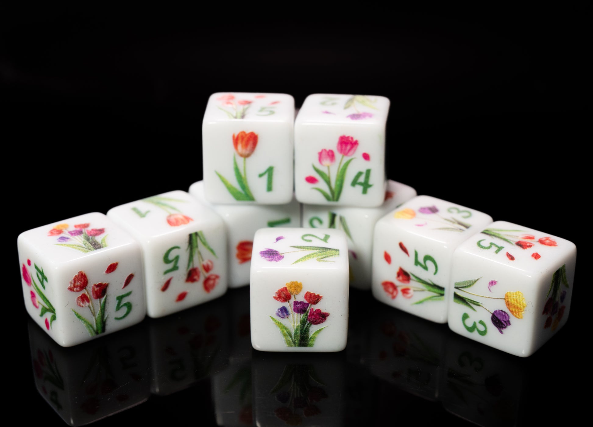 Set of d6 six sided dice with tulip floral designs on a black background for Yahtzee and other dice games