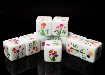 Set of d6 six sided dice with tulip floral designs on a black background for Yahtzee and other dice games