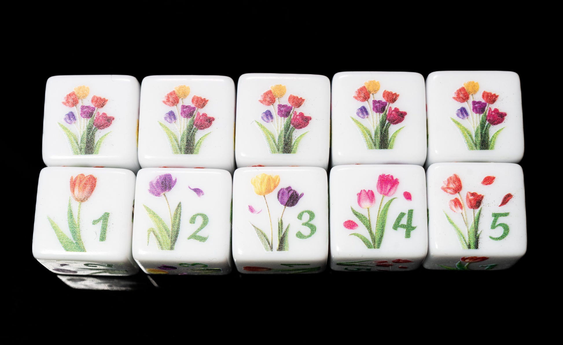Set of d6 six sided dice with tulip floral designs on a black background for Yahtzee and other dice games