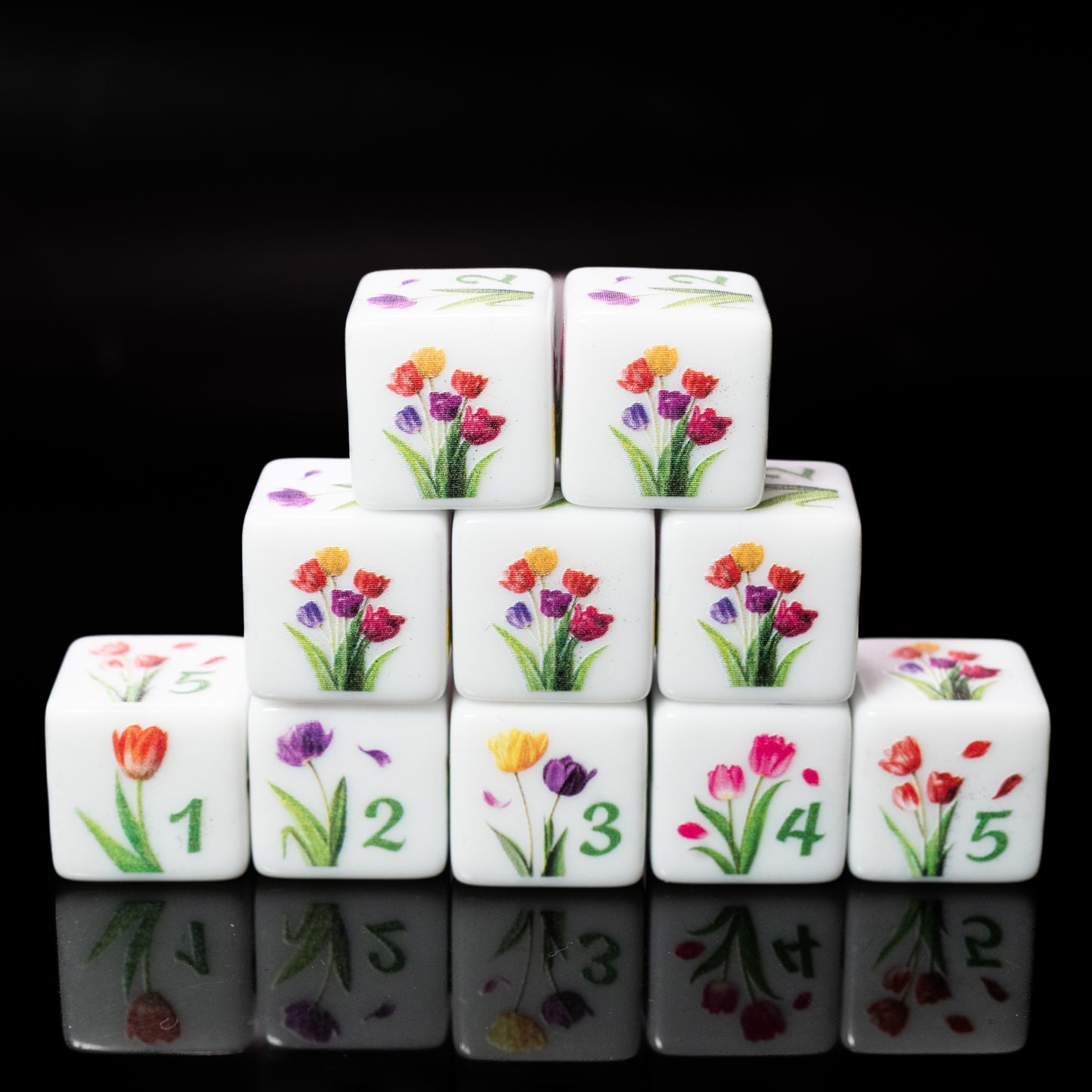 Set of d6 six sided dice with tulip floral designs on a black background for Yahtzee and other dice games