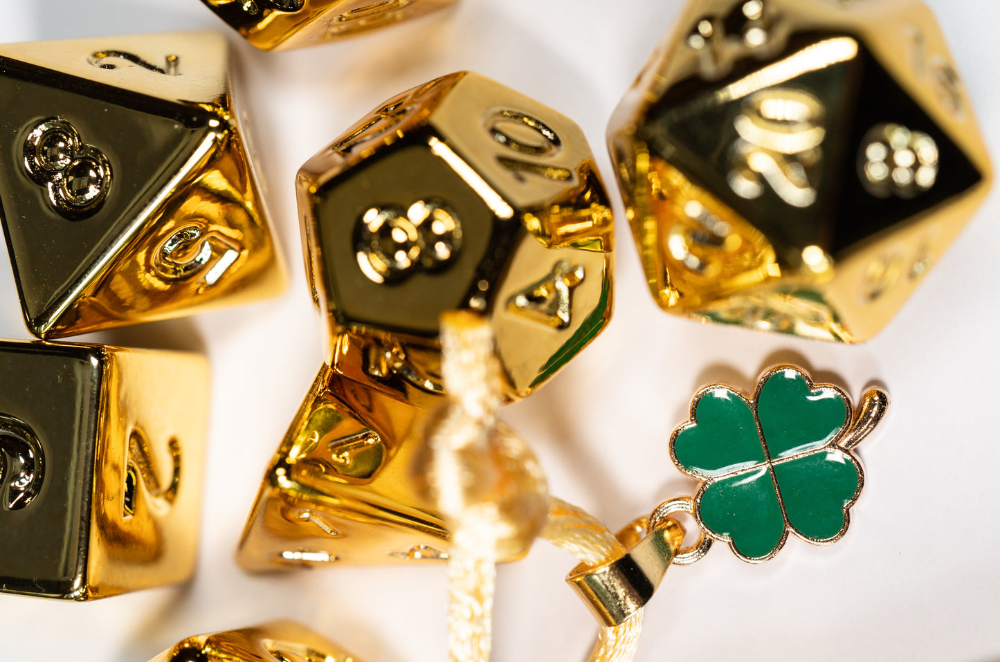 these dice are lucky golden acrylic four leaf clover dungeons and dragons (aka dnd or d&d) game dice set, including a d20, d12, d10, d8, d6, and d4
