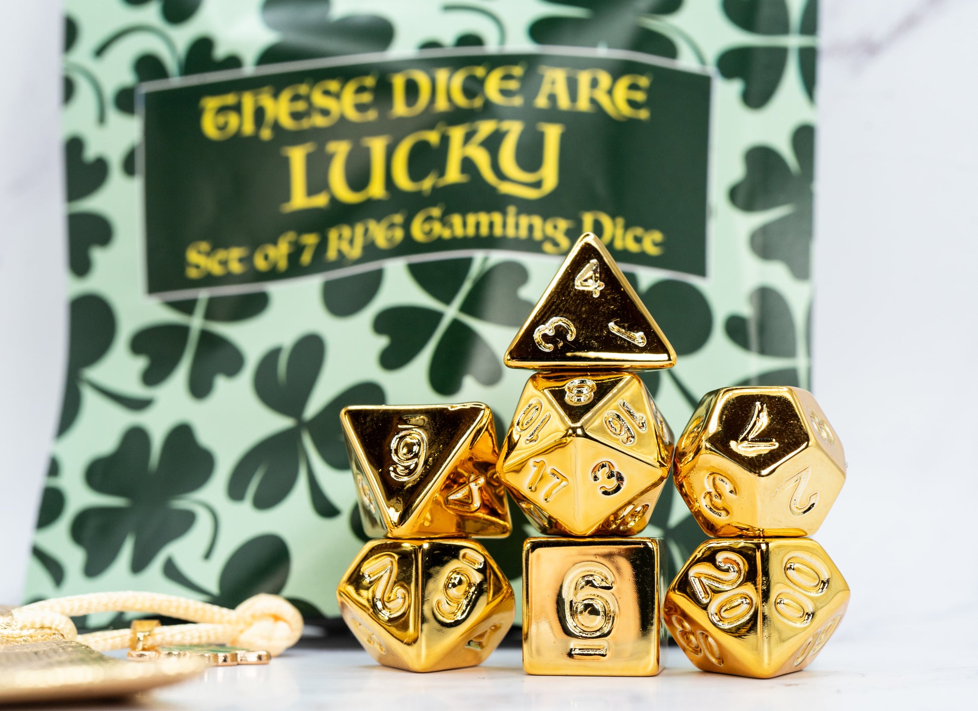 these dice are lucky golden acrylic four leaf clover dungeons and dragons (aka dnd or d&d) game dice set, including a d20, d12, d10, d8, d6, and d4