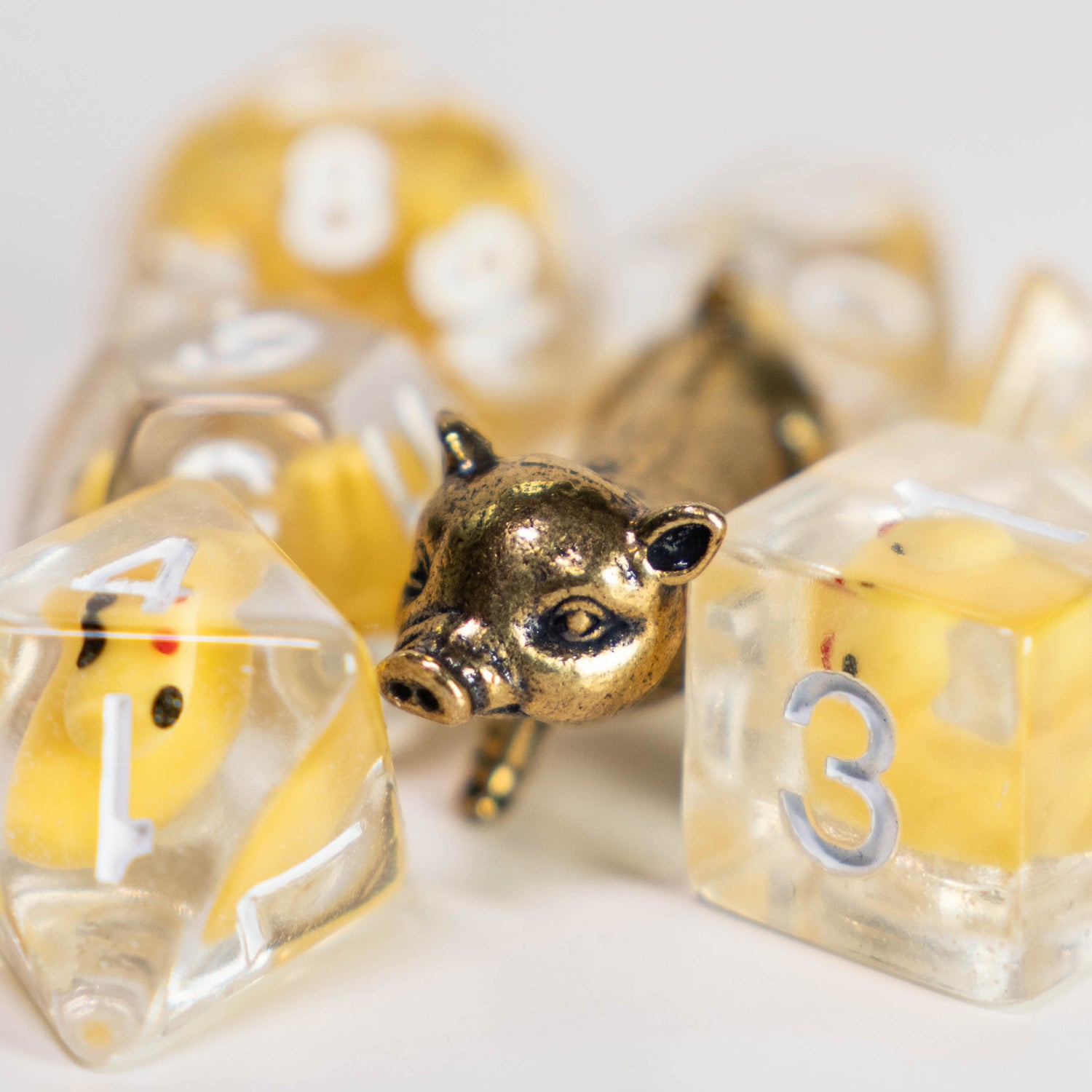lucky duck resin dungeons and dragons (aka dnd or d&d) game dice set, including 1d20, d12, d10, d8, d6, d4, with a gold pig figurine
