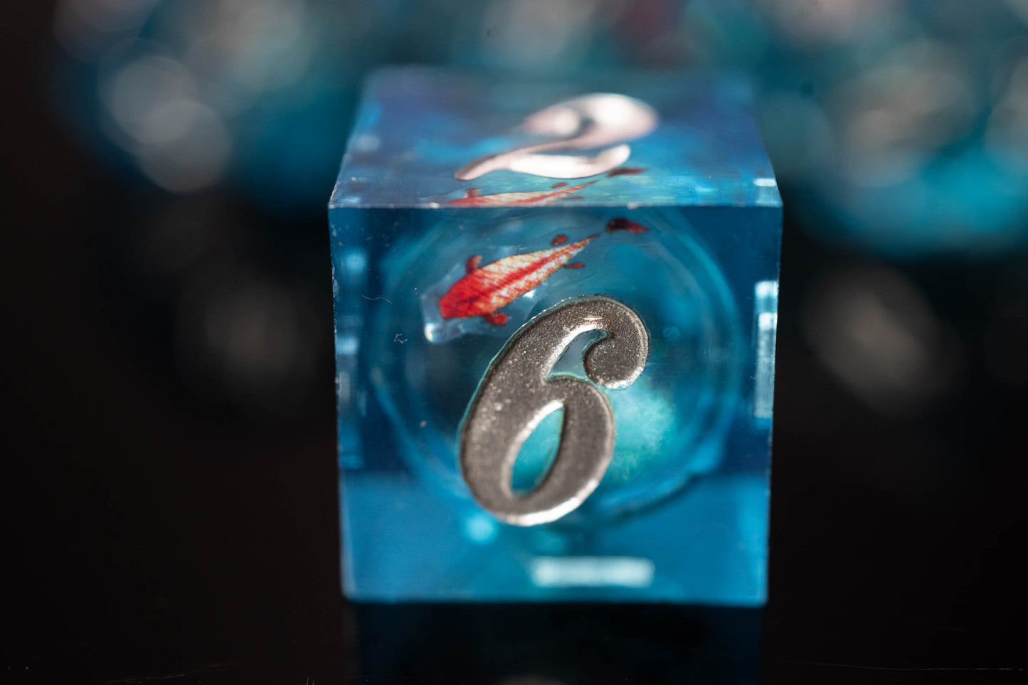 these dice are lucky sharp edge resin koi fish dungeons and dragons (aka dnd or d&d) game dice set, including a d20, d12, d10, d8, d6, and d4