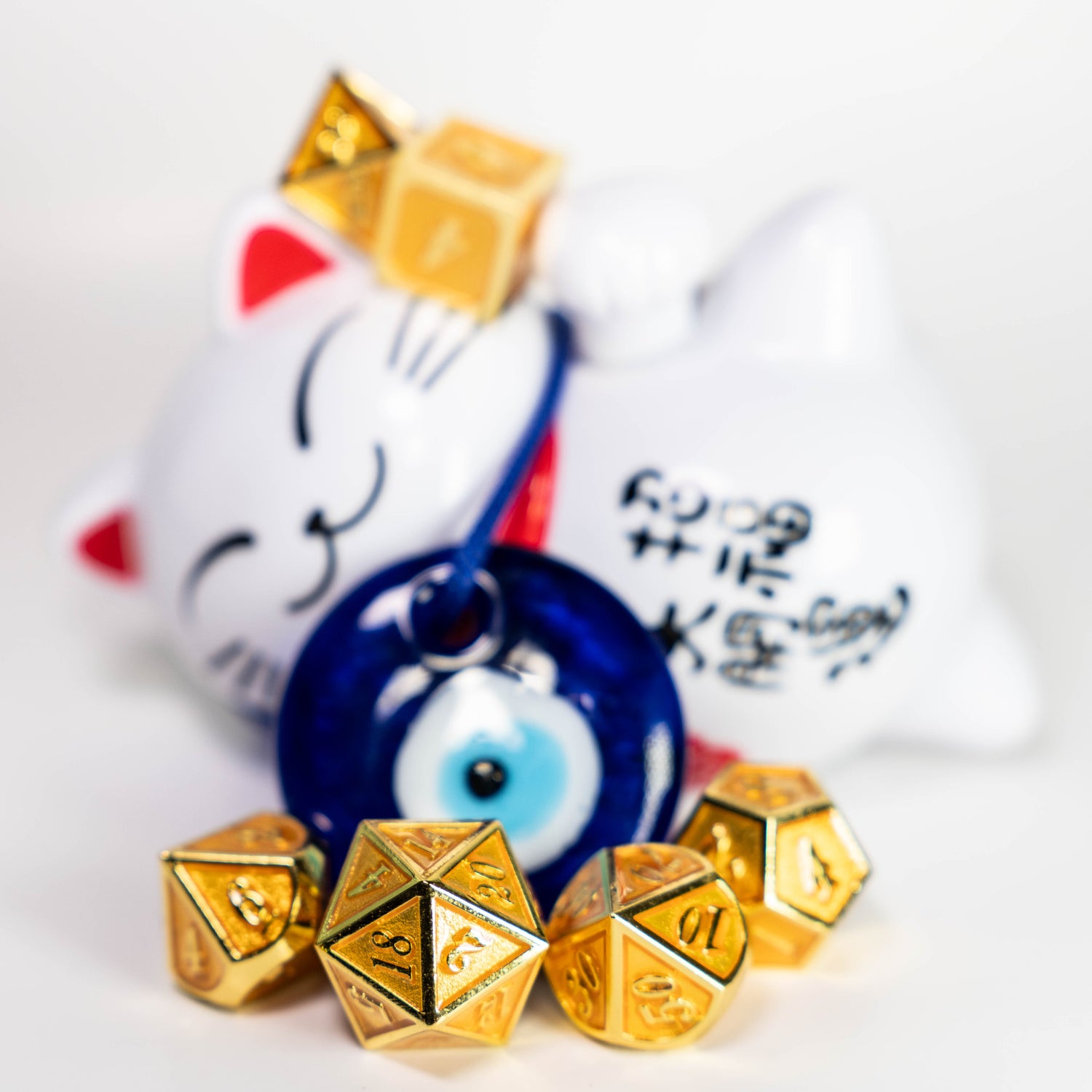 lucky gold metal dungeons and dragons (aka dnd or d&d) game dice set, including 1d20, d12, d10, d8, d6, d4, with an evil eye charm and maneki Neko

