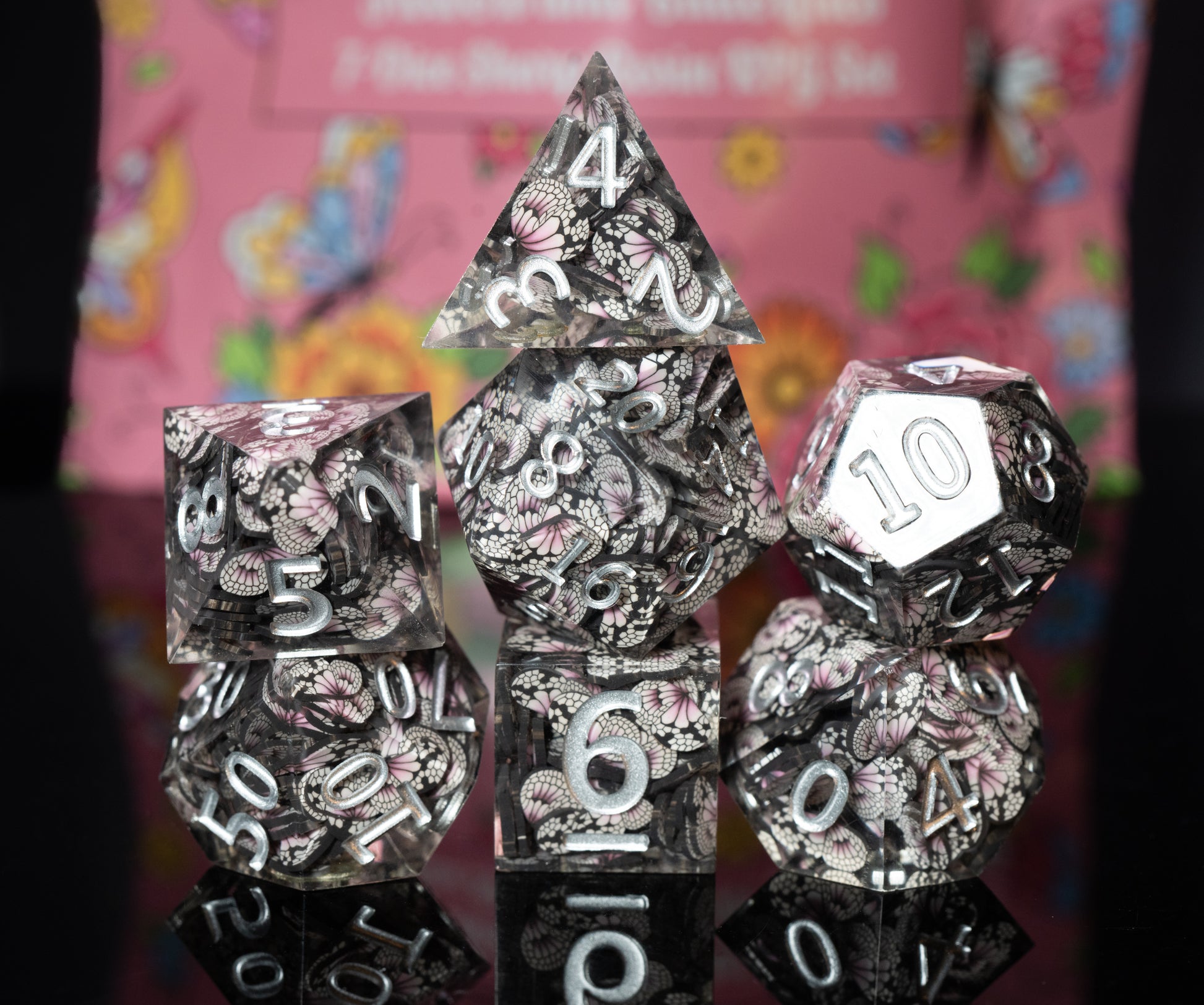 mystery sharp edge resin flowers and butterflies dungeons and dragons (aka dnd or d&d) game dice set, including a d20, d12, d10, d8, d6, and d4